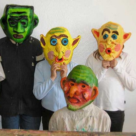 Teilnehmende an der Jungendkunstschule tragen selbst gestalteten Masken 