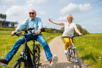 Seniors having fun on bicycles in spring